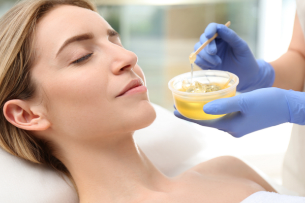 woman getting wax epilation