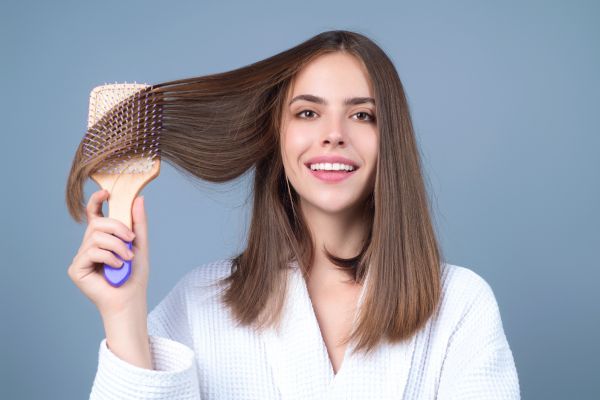 young woman brushing hair